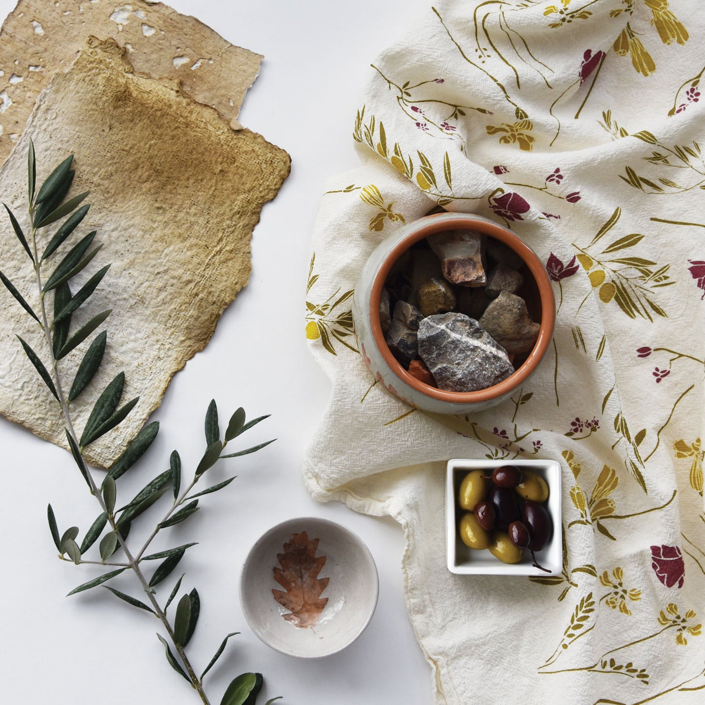 Kitchen tea towel featuring the Olive Grove design alongside a few olives, designed by Katie Forte of june & december