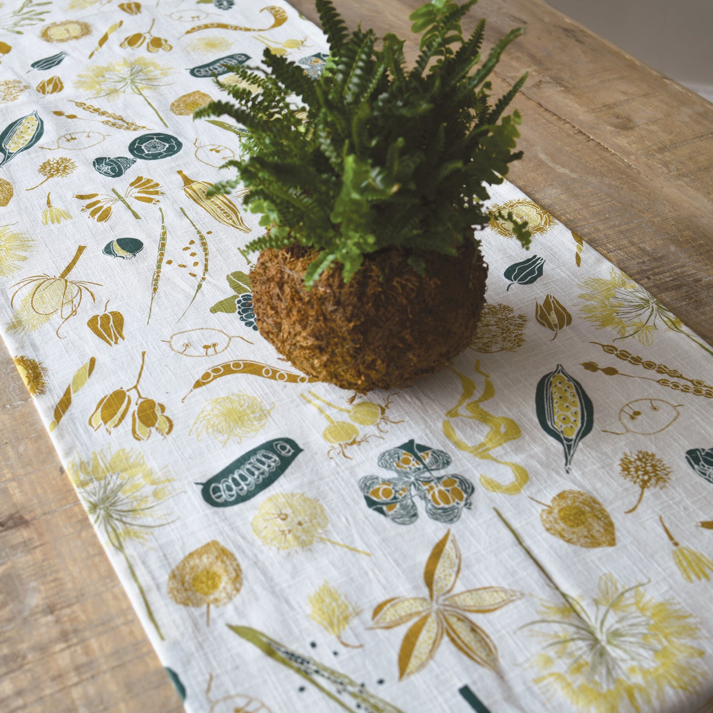 Designer Table Runner with organic cotton featuring  botanical nature seed pods artwork by June & December artist Katie Forte