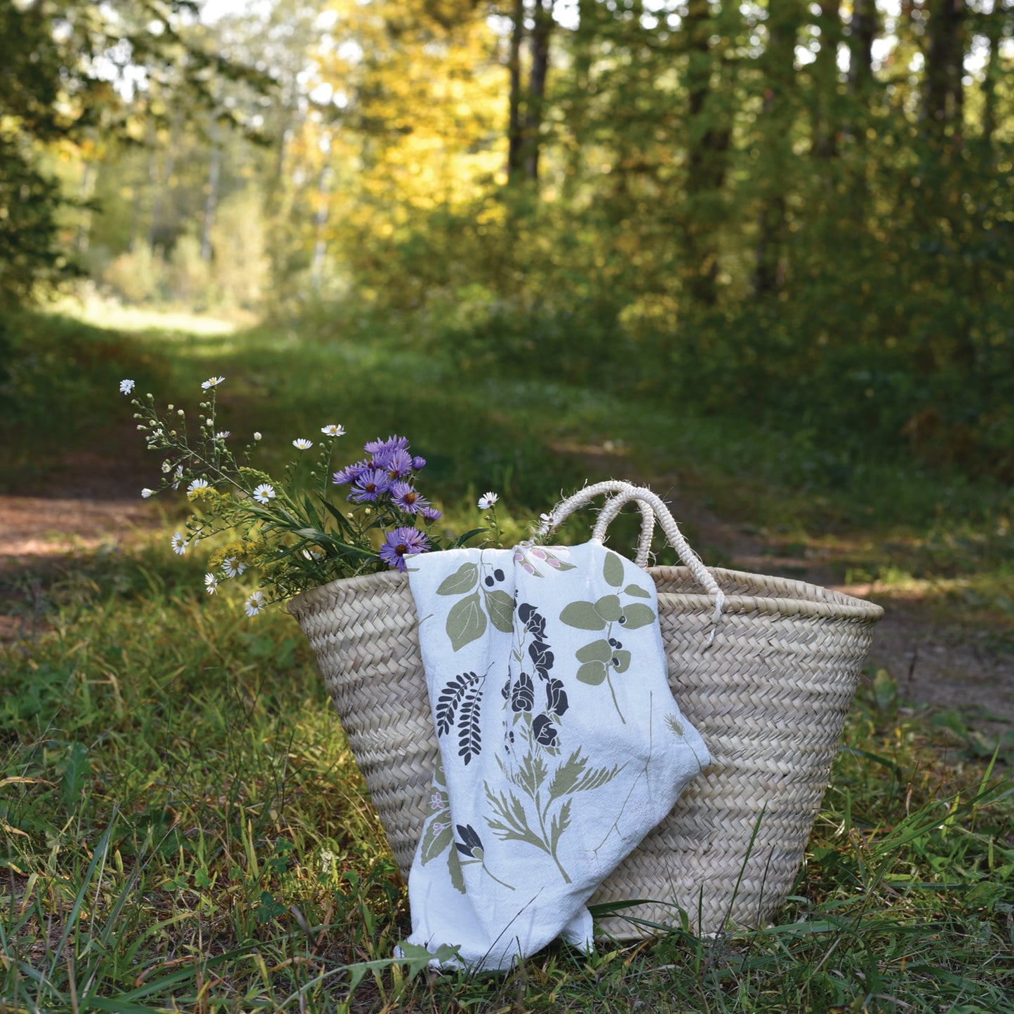 Tea towel flour sack featuring some Poisonous and Prickly elements in the forest, designed by Katie Forte of june & december