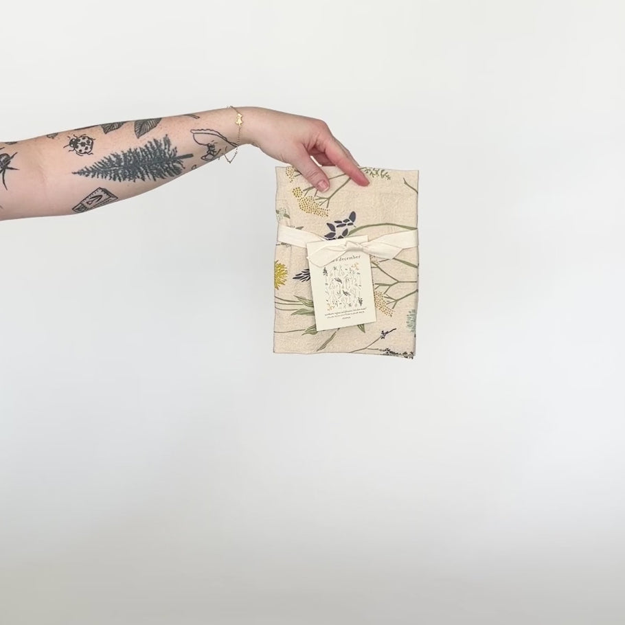 Load and play video in Gallery viewer, Video featuring our Northern Wildflowers tea towel design in natural. Made from flour sack cotton, designed by Katie Forte of June &amp;amp; December
