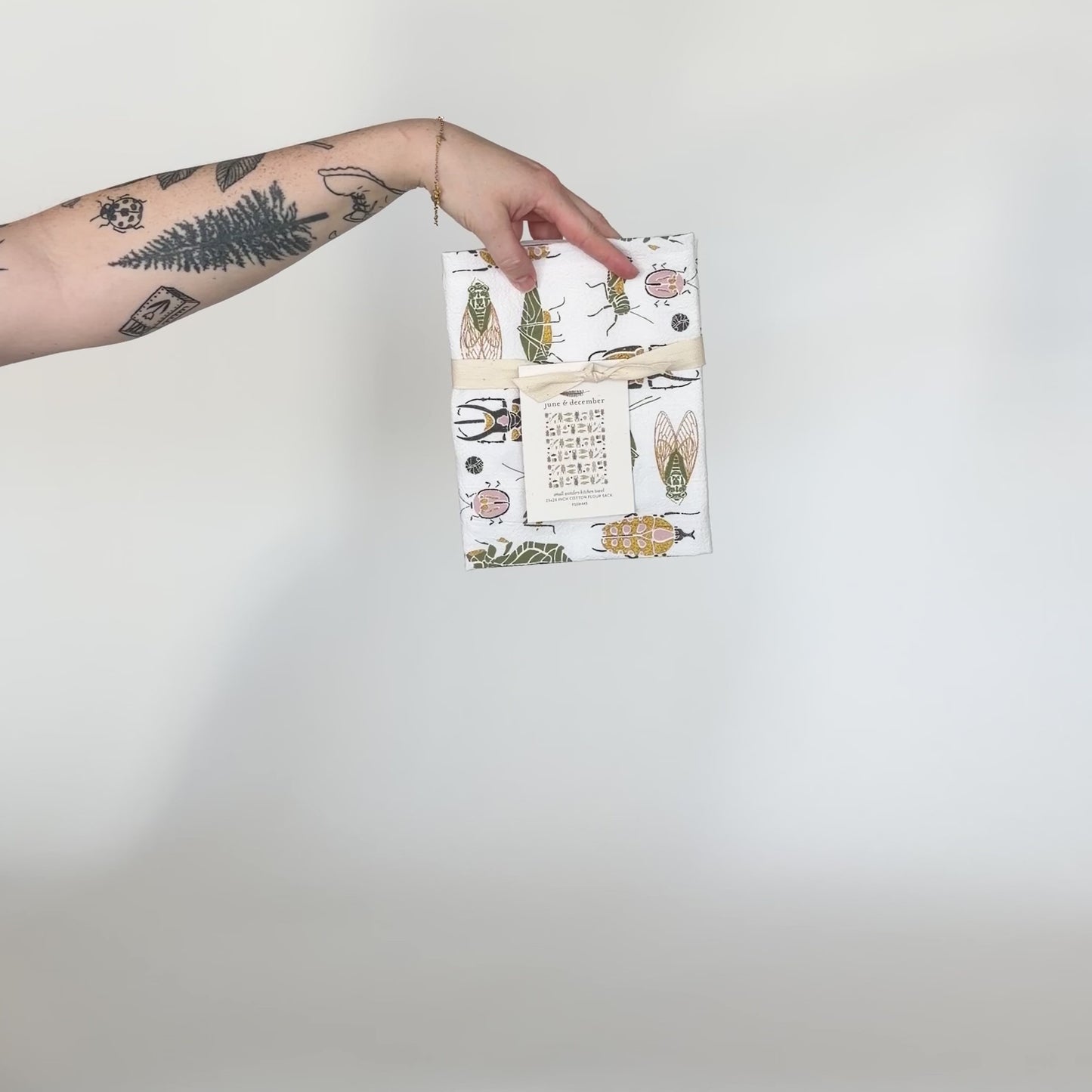 Load and play video in Gallery viewer, Video featuring our Small Wonders tea towel design. Accented with gold glitter, and printed on flour sack cotton. Designed by Katie Forte of June &amp;amp; December
