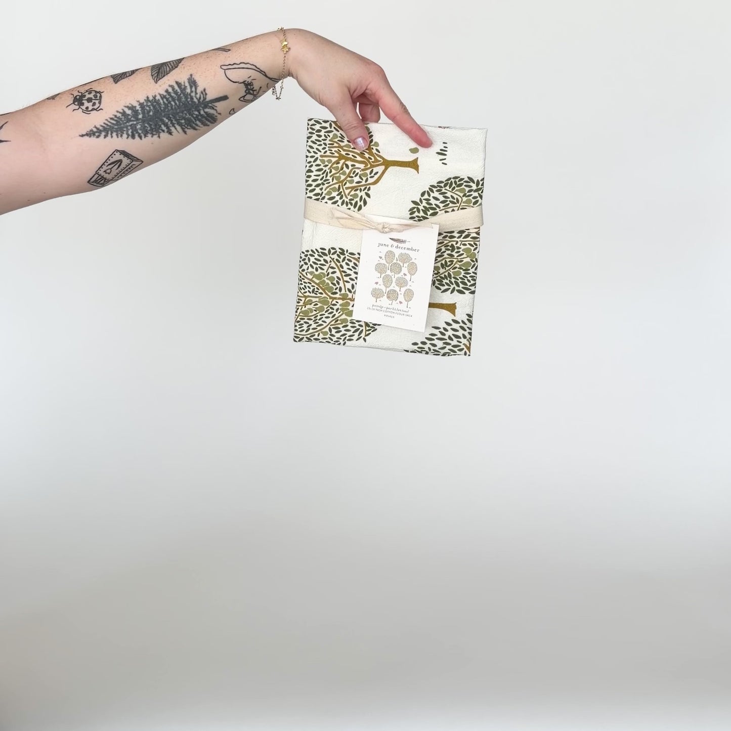 Load and play video in Gallery viewer, Video featuring our Partridge and Pear tea towel design. Printed on flour sack cotton, and perfect to display during the holiday. Designed by Katie Forte of June &amp;amp; December
