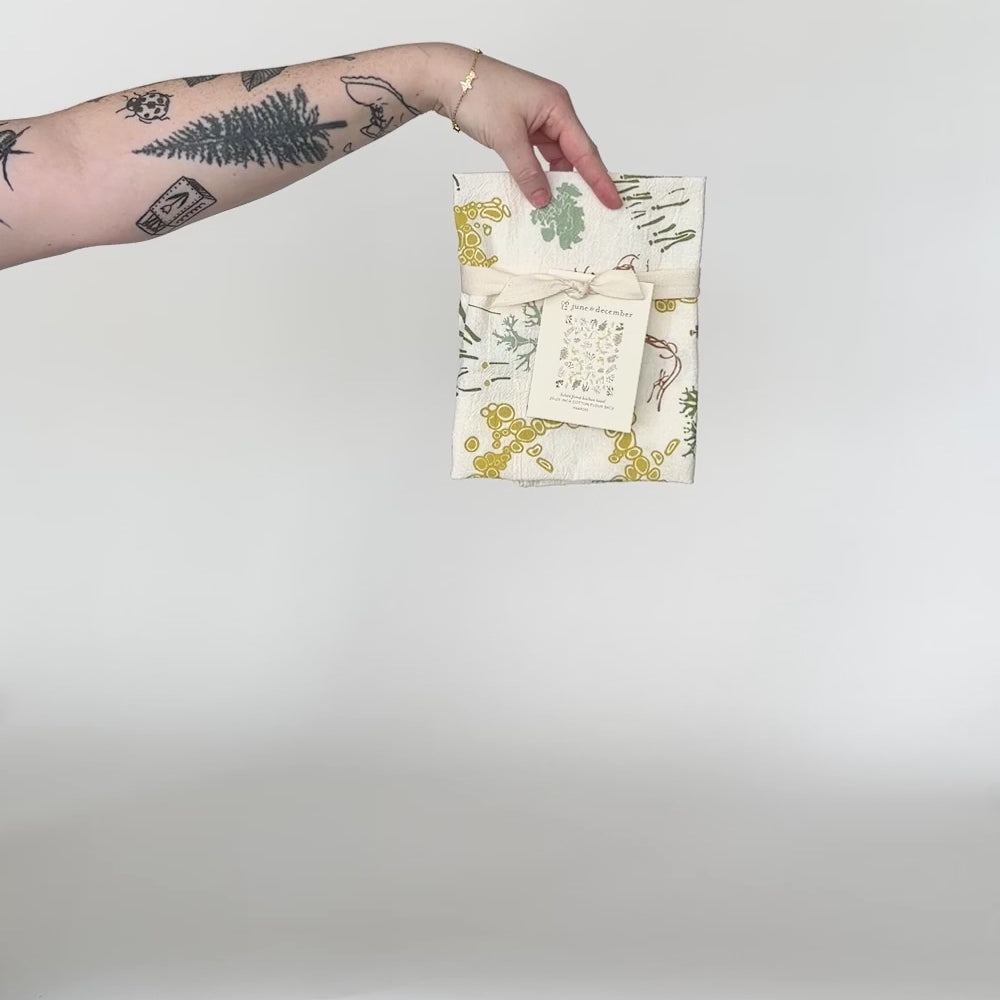 Load and play video in Gallery viewer, Video featuring our Lichen Forest tea towel design. Screen printed on flour sack cotton, this a perfect gift for the forest forager. Designed by Katie Forte of June &amp;amp; December

