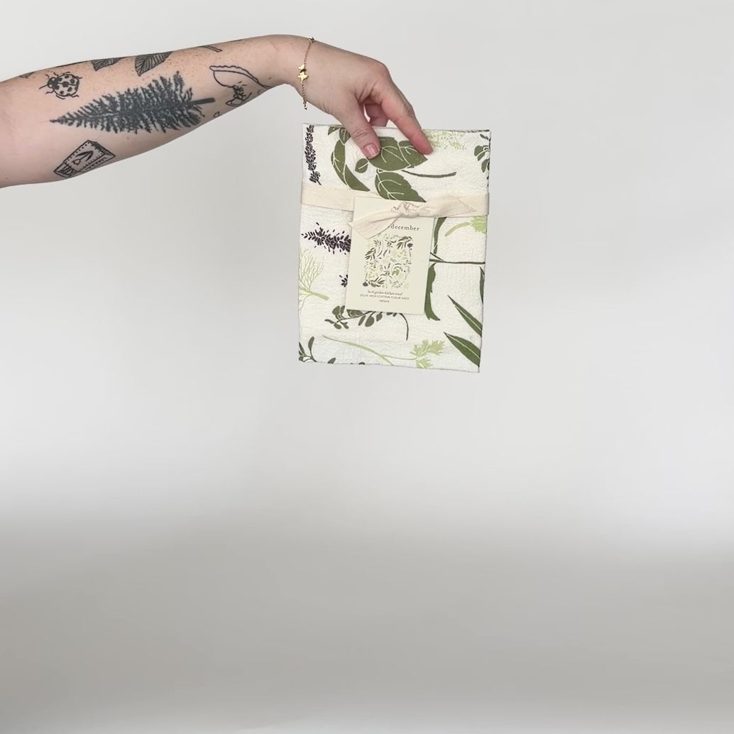 Load and play video in Gallery viewer, Video featuring our Herb Garden tea towel design. Screen printed on flour sack cotton, a perfect gift for someone who like being in the kitchen. Designed by Katie Forte of June &amp;amp; December
