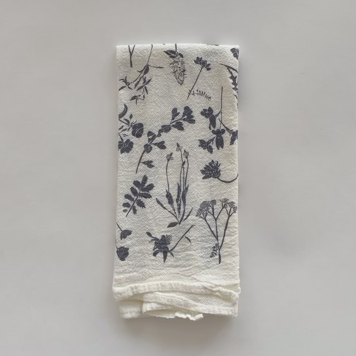 Load and play video in Gallery viewer, Short video featuring our Navy Wildflowers design on a eco-friendly cloth napkin, showing both sides, designed by Katie Forte of June &amp;amp; December
