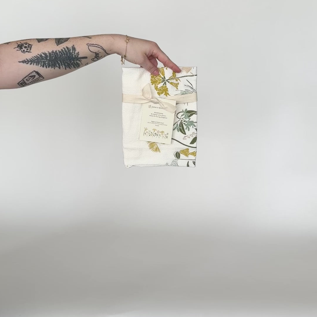 Load and play video in Gallery viewer, Video showing one of our Language of Flowers tea towel, featuring Happiness flowers, printed on flour sack cotton, designed by Katie Forte of June &amp;amp; December

