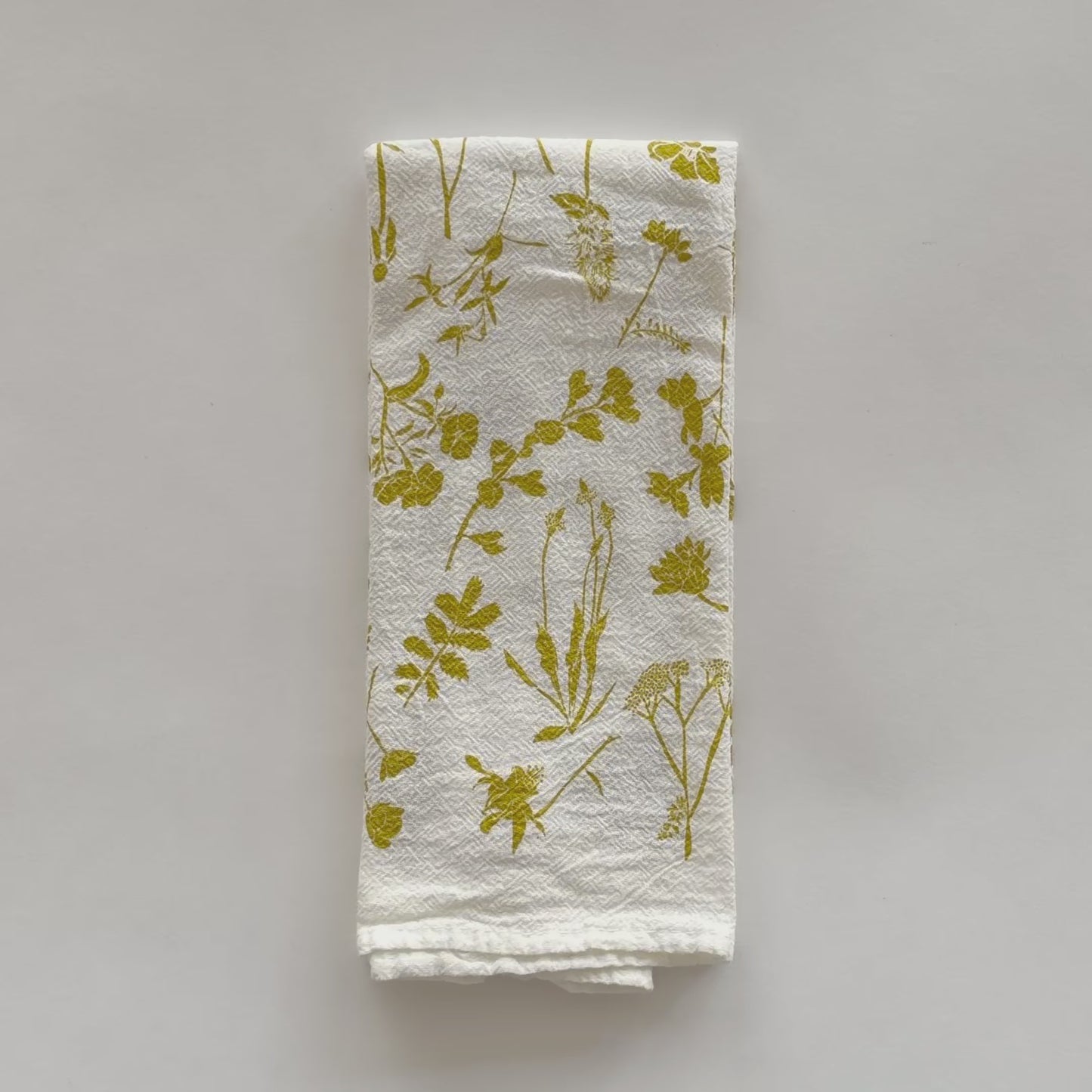 Load and play video in Gallery viewer, Video featuring an eco-friendly cloth napkin with a Yellow Wildflowers design, designed by Katie Forte of June &amp;amp; December
