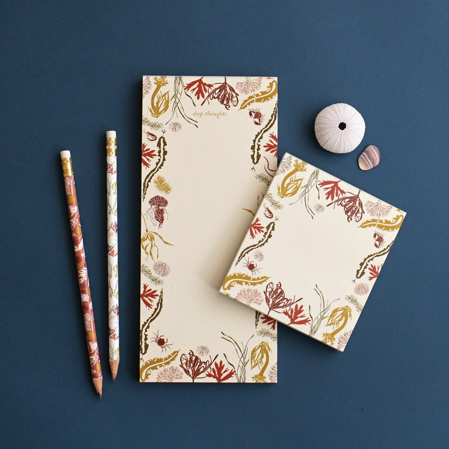 Recycled paper Sea Wilds mini shown next to its larger notepad designed with ocean elements to help you channel beach thoughts designed by katie forte of june & december
